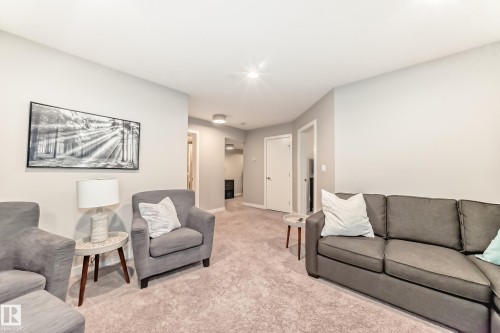 This inviting living area features light-colored carpeting, recessed lighting, and light-toned walls - 11 Etoile Cres N, St. Albert, AB - Indoor Photo Showing Living Room