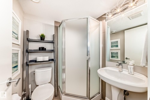 This bathroom features a contemporary pedestal sink, a toilet, and a glass-enclosed shower - 11 Etoile Cres N, St. Albert, AB - Indoor Photo Showing Bathroom
