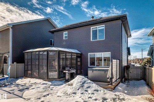 The property features a private backyard with a screened enclosure, a hot tub, and a wooden fence - 11 Etoile Cres N, St. Albert, AB - Outdoor With Exterior