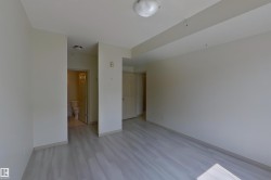 Unfurnished bedroom featuring light wood finished floors and ensuite bathroom - 