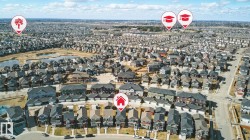 Aerial view of the neighborhood showcasing residential properties, a nearby pond, and accessible roads - 