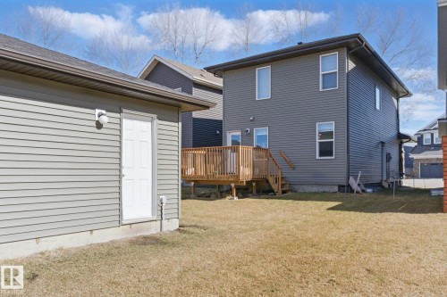 The property features a spacious yard with a deck and a detached garage, offering ample outdoor enjoyment and utility - 2416 Wonnacott Crest, Edmonton, AB - Outdoor With Deck Patio Veranda With Exterior