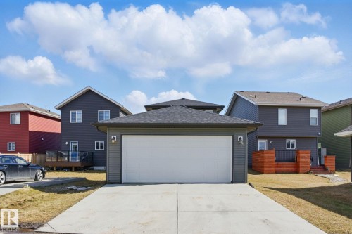 The property features a double garage with a concrete driveway - 2416 Wonnacott Crest, Edmonton, AB - Outdoor