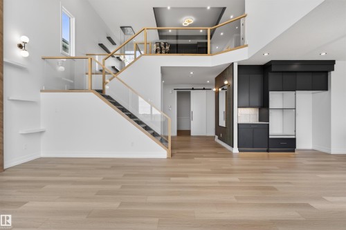 Open-concept interior featuring light wood-finish flooring throughout the main level - 63 Jubilation Drive, St. Albert, AB - Indoor Photo Showing Other Room
