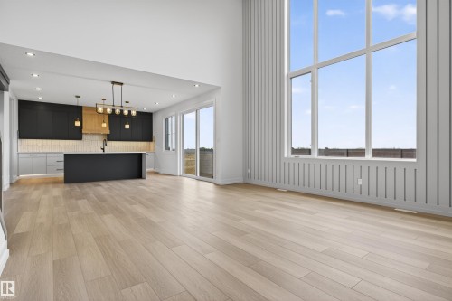 Open-concept living area with high ceilings and wood-finish flooring - 63 Jubilation Drive, St. Albert, AB - Indoor Photo Showing Kitchen