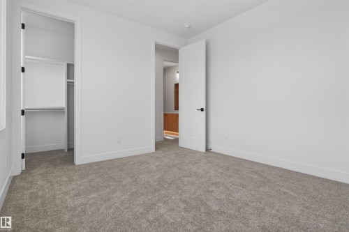Neutral-toned carpeting complements bright white walls - 63 Jubilation Drive, St. Albert, AB - Indoor Photo Showing Other Room