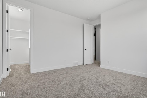 Spacious room with light gray carpet flooring and white painted walls - 63 Jubilation Drive, St. Albert, AB - Indoor Photo Showing Other Room