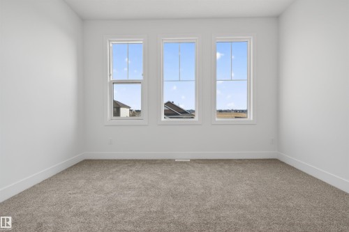 Three large windows provide abundant natural light - 63 Jubilation Drive, St. Albert, AB - Indoor Photo Showing Other Room