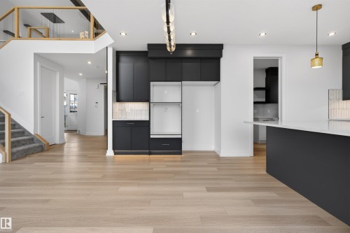 Modern open-concept interior featuring light wood-finish flooring throughout - 63 Jubilation Drive, St. Albert, AB - Indoor Photo Showing Other Room