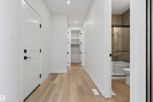 Hallway featuring light wood-finish flooring, white walls, and recessed lighting - 63 Jubilation Drive, St. Albert, AB - Indoor Photo Showing Other Room