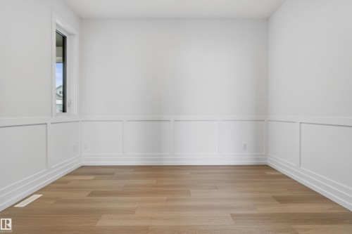 Room featuring light wood-finish flooring, white walls, and wainscoting detailing - 63 Jubilation Drive, St. Albert, AB - Indoor Photo Showing Other Room
