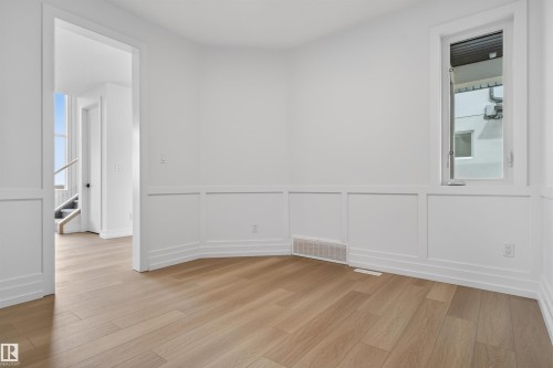 Room featuring light wood-finish flooring, white wainscoting, and crisp white walls - 63 Jubilation Drive, St. Albert, AB - Indoor Photo Showing Other Room
