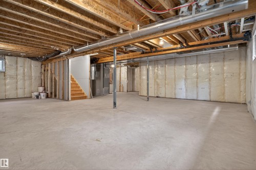 Spacious unfinished lower level featuring exposed wood joists, concrete flooring, and insulated perimeter walls - 63 Jubilation Drive, St. Albert, AB - Indoor Photo Showing Basement
