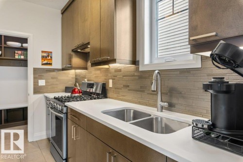 Secondary Main Floor Kitchen featuring Gas Stove, ample cabinet and counter space, and additional sink - 4476 Suzanna Crescent, Edmonton, AB - Indoor Photo Showing Kitchen