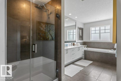 Primary Ensuite featuring Separate Glass and Tile Shower, Jacuzzi Bathtub, White Cabinets and Quartz Counters, and Separate Water Closet - 4476 Suzanna Crescent, Edmonton, AB - Indoor Photo Showing Bathroom