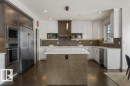 Kitchen Features Dark Hardwood Flooring, Two Tone Kitchen Cabinets, Gas Stove, Wall Oven, and White Quartz Counters - 4476 Suzanna Crescent, Edmonton, AB  - Indoor Photo Showing Kitchen 