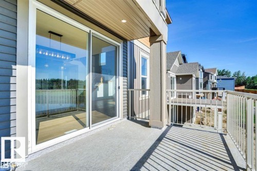 The property features an exterior balcony with a concrete floor and a white metal railing - 47 Rosewood Way, St. Albert, AB - Outdoor With Balcony With Deck Patio Veranda With Exterior