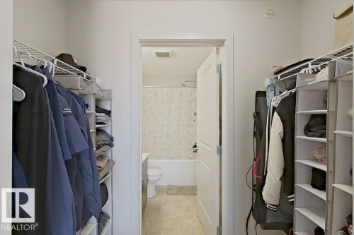 Walk-in closet with built-in shelving and hanging rods - 429 390 Windermere Rd, Edmonton, AB - Indoor With Storage