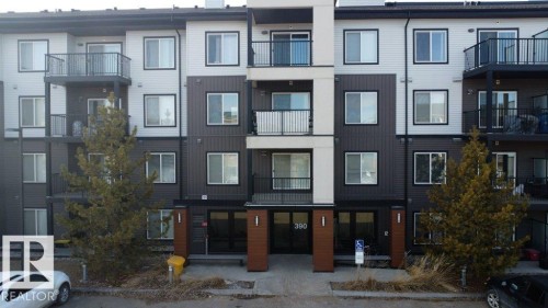 The property features a multi-story building with a modern facade, including balconies with dark railings - 429 390 Windermere Rd, Edmonton, AB - Outdoor With Balcony With Facade