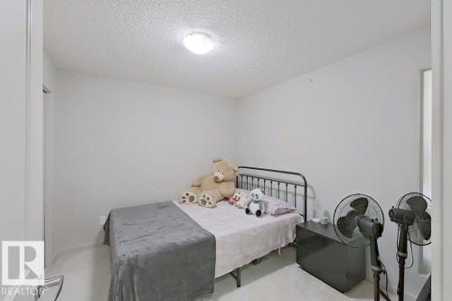 Room featuring light-colored walls and a ceiling light fixture - 429 390 Windermere Rd, Edmonton, AB - Indoor Photo Showing Bedroom