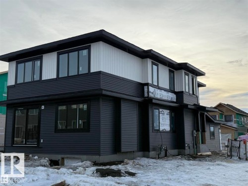 The property features a contemporary exterior with dark gray siding on the lower level and white vertical siding on the upper level - 29 Redbud Way, St. Albert, AB - Outdoor