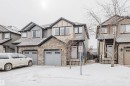 View of front of home featuring stone siding and a garage - Edmonton, AB  - Outdoor With Facade 