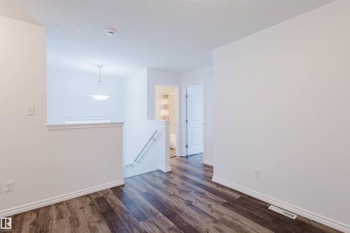 Unfurnished room featuring dark wood finished floors and a textured ceiling - Edmonton, AB - Indoor Photo Showing Other Room