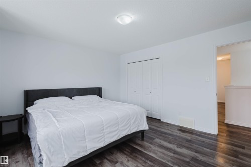 Bedroom featuring dark wood-type flooring and a closet - Edmonton, AB - Indoor Photo Showing Bedroom