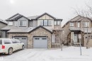 Craftsman-style house featuring stone siding, an attached garage, and roof with shingles - Edmonton, AB  - Outdoor With Facade 