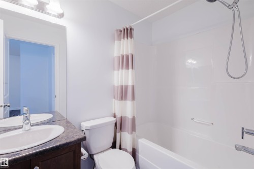 Bathroom featuring vanity and shower / tub combo - Edmonton, AB - Indoor Photo Showing Bathroom