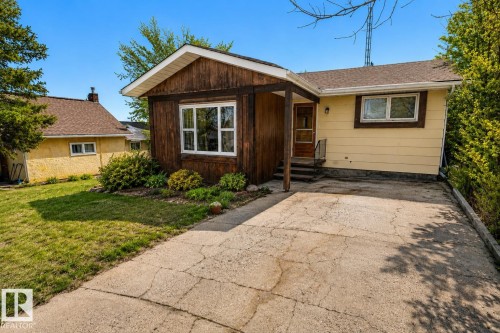 Front exterior featuring a combination of horizontal siding and vertical wood paneling - 5016 47 St, Myrnam, AB - Outdoor