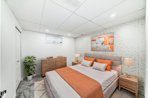 Bedroom with an accent wall, recessed lighting, wallpapered walls, a paneled ceiling, and a closet - 4008 37 Avenue, Edmonton, AB - Indoor Photo Showing Bedroom