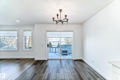 Unfurnished dining area featuring wood tiled floors and suspended lighting - 4008 37 Avenue, Edmonton, AB - Indoor