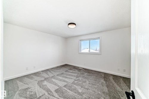Empty room with light carpet and baseboards - 4008 37 Avenue, Edmonton, AB - Indoor Photo Showing Other Room