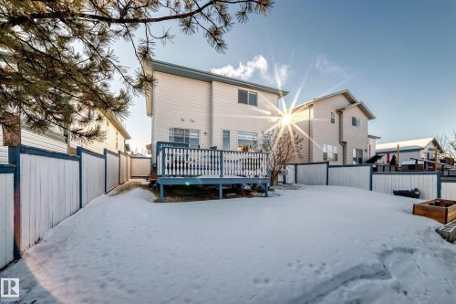 Snow covered rear of property featuring a fenced backyard and a deck - 4008 37 Avenue, Edmonton, AB - Outdoor With Exterior