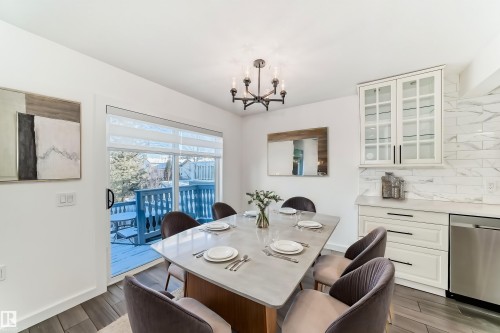 Dining space featuring wood finish floors and suspended lighting - 4008 37 Avenue, Edmonton, AB - Indoor Photo Showing Dining Room
