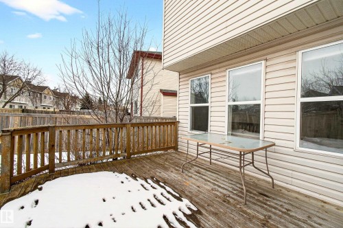 Spacious outdoor deck area featuring a wooden railing and a view of the surrounding properties - 8922 5 Avenue, Edmonton, AB - Outdoor With Exterior