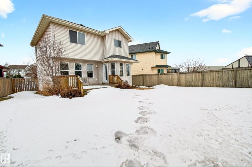 The property features a private backyard with a wooden fence and a deck extending from the back of the home - 8922 5 Avenue, Edmonton, AB - Outdoor