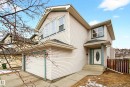 The property features a two-story exterior with siding, a front entry with a covered porch, and an attached garage - 8922 5 Avenue, Edmonton, AB  - Outdoor 
