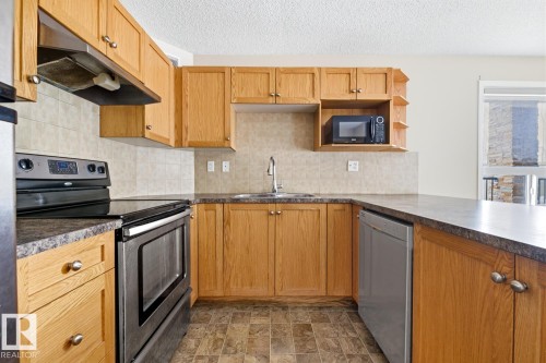 125 1520 Hammond Gate Nw, Edmonton, AB - Indoor Photo Showing Kitchen With Stainless Steel Kitchen