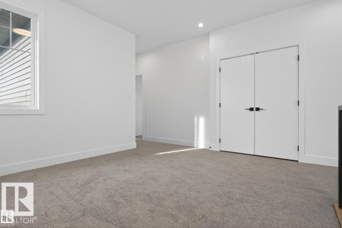 This room features light gray carpeting, white walls, and a window providing natural light - 5 Rosa Crescent, St. Albert, AB - Indoor Photo Showing Other Room