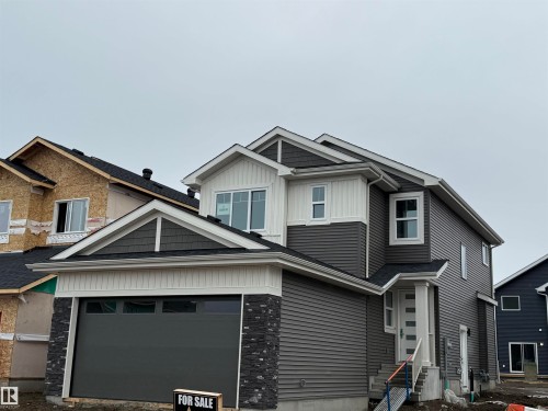 The property features a two-story exterior with dark grey siding and white trim - 11 Redbud Way, St. Albert, AB - Outdoor