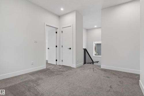 This interior space features light grey carpeting, white walls, and white trim - 11 Redbud Way, St. Albert, AB - Indoor Photo Showing Other Room