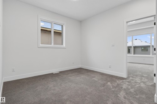 This room features neutral-toned carpet, white walls, and a window providing natural light - 11 Redbud Way, St. Albert, AB - Indoor Photo Showing Other Room