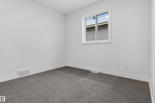 This room features light grey walls, white trim, and dark grey carpeting, creating a neutral palette - 11 Redbud Way, St. Albert, AB - Indoor Photo Showing Other Room
