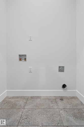 Utility area featuring white walls, a tile floor, and baseboards - 11 Redbud Way, St. Albert, AB - Indoor Photo Showing Other Room