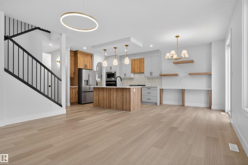Open concept living area featuring light-toned hardwood flooring throughout - 11 Redbud Way, St. Albert, AB - Indoor Photo Showing Kitchen