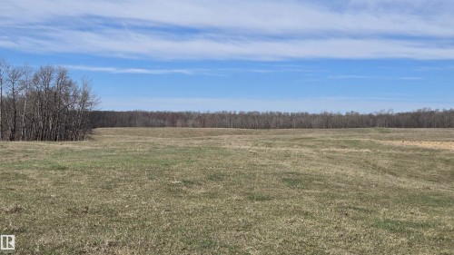 Expansive open land featuring natural grass, gently rolling topography, and a distant tree line - 11 Twin Lakes Drive, Rural Lamont County, AB 