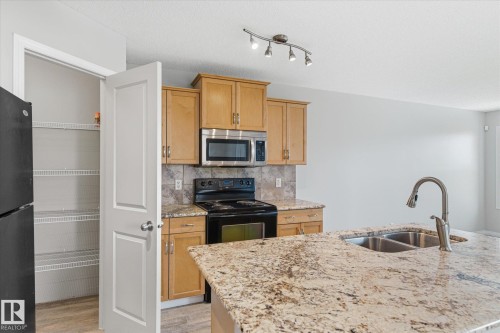 424 Songhurst Place, Leduc, AB - Indoor Photo Showing Kitchen With Double Sink