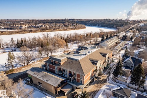 The property features a multi-story building with a brown shingled roof, red brick exterior, and balconies - 307 9750 94 Street, Edmonton, AB - Outdoor With View